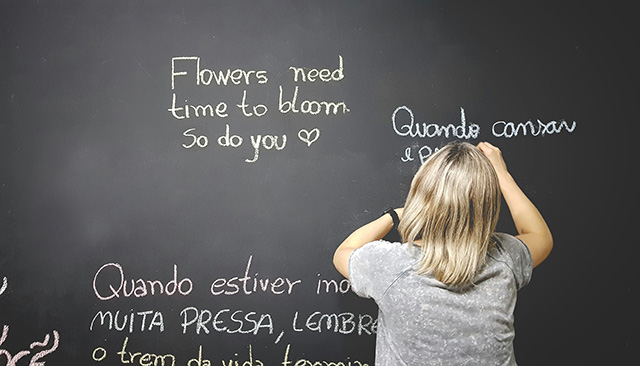 Child translating into Spanish on a chalkboard