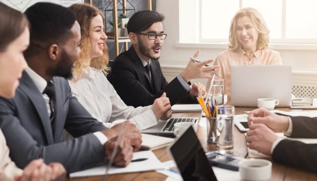 Group of business people sitting at table.