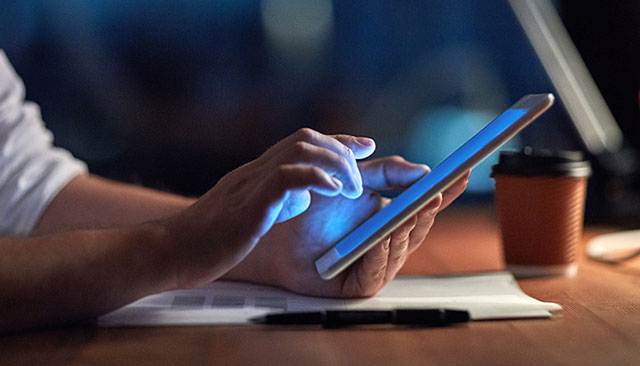 person using tablet for research