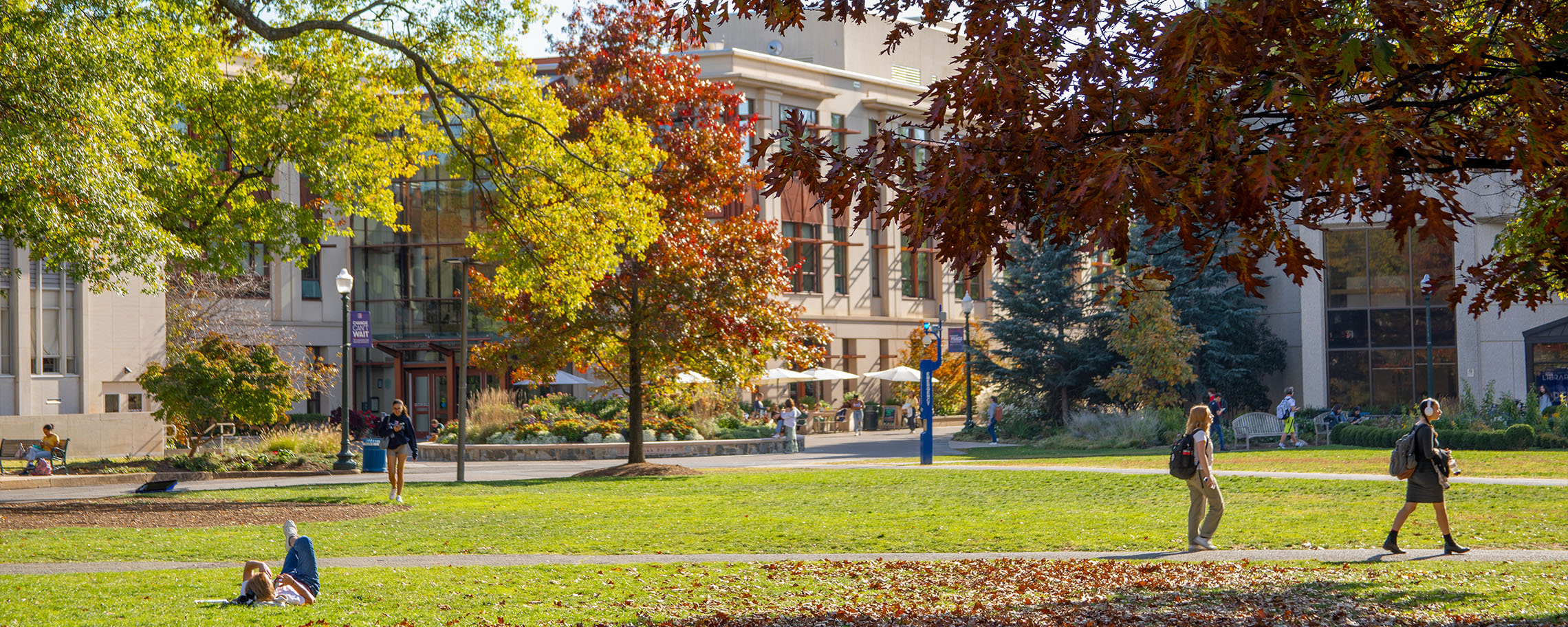 Students walk across the Quad in autumn.