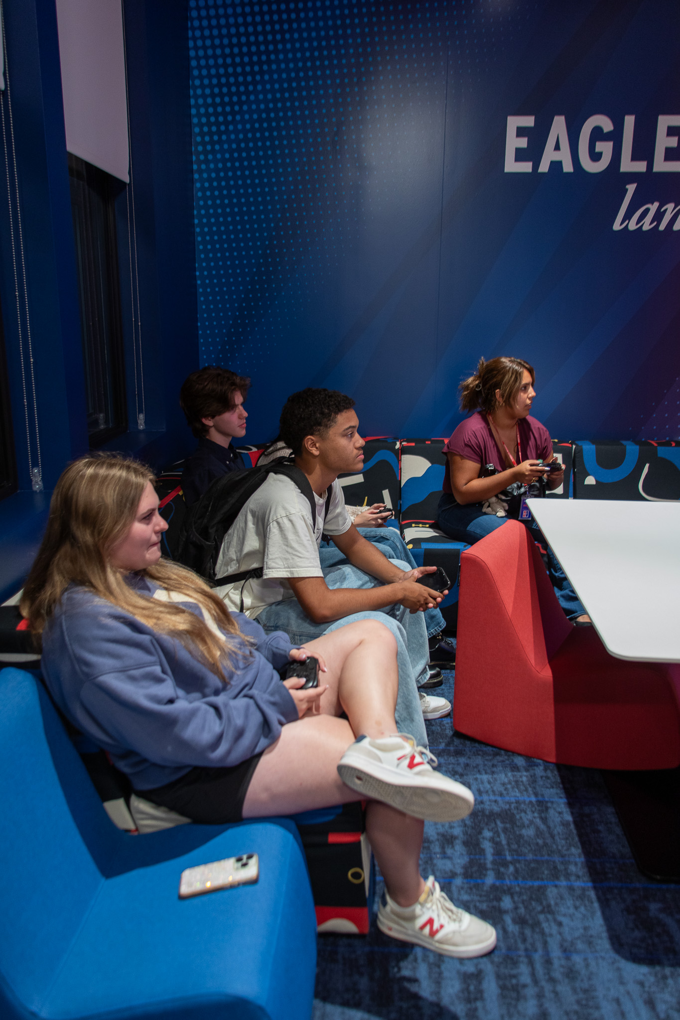 Students sit on couches holding Nintendo Switch controllers as they play a game in the gaming zone on the second floor of Mary Graydon Student Center.