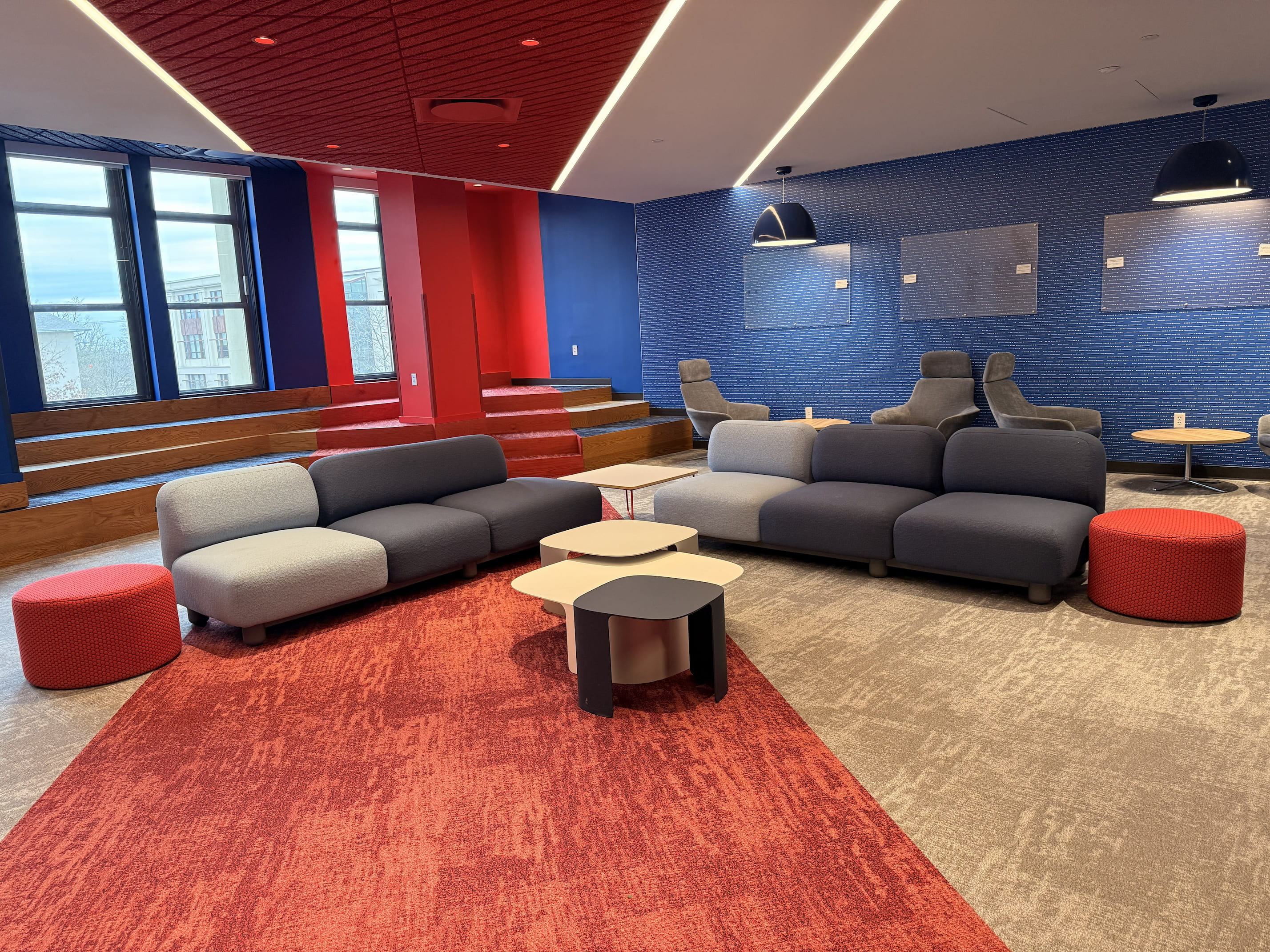 Lounge with several couches and windows on the far wall.