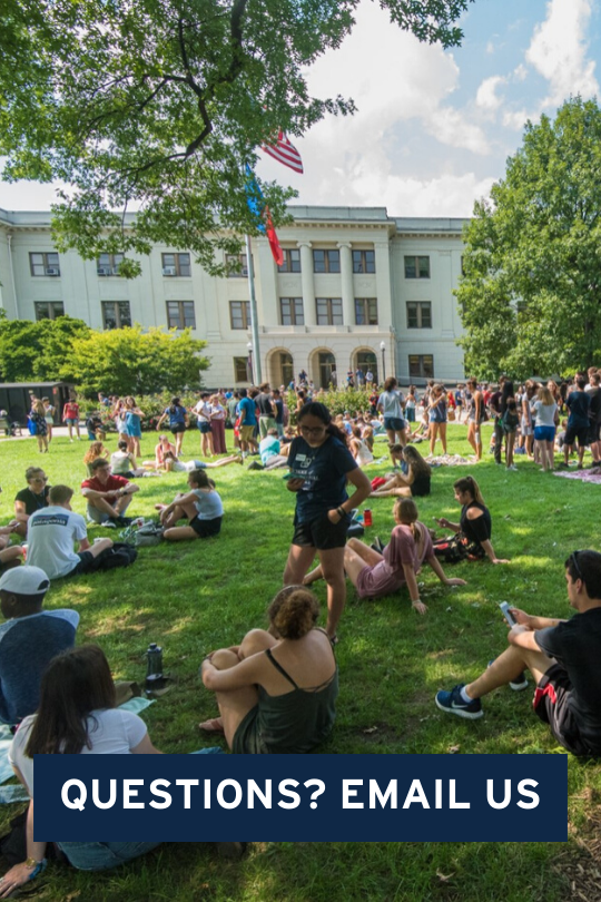 Students sitting outside on the quad together.