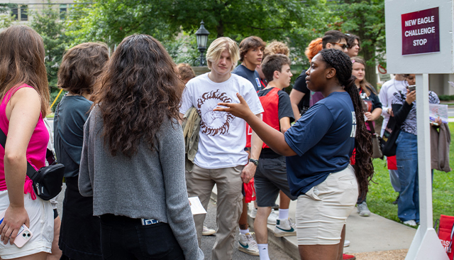 An Orientation Leader speaks to new AU students at a New Eagle Stop.